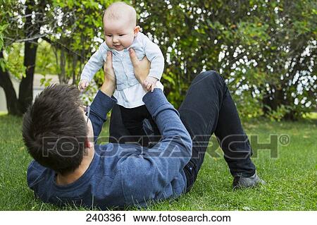 Stock Image - Father spending quality time with his infant daughter; Edmonton, Alberta, Canada. Fotosearch