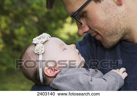Father with his infant daughter in a park; Edmonton, Alberta, Canada View Large Photo Image Stock Image - Father with his infant daughter in a park; Edmonton, Alberta, Canada. Fotosearch