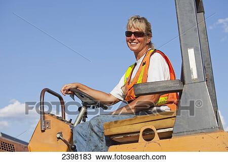 Female operator driving steam roller for repairing pot holes in a parking lot; Edmonton, Alberta, Canada View Large Photo Image Stock Image - Female operator driving steam roller for repairing pot holes in a parking lot; Edmonton, Alberta, Canada. Fotosearch