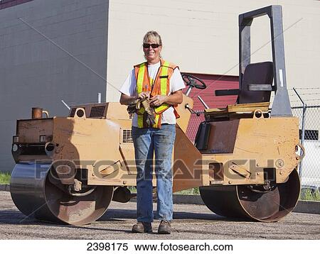 Female operator with a steam roller for repairing pot holes in a parking lot; Edmonton, Alberta, Canada View Large Photo Image Stock Photography - Female operator with a steam roller for repairing pot holes in a parking lot; Edmonton, Alberta, Canada. Fotosearch