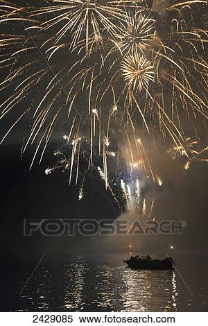 Fireworks display over a lake illuminating the boats on the water; Kenora, Ontario, Canada View Large Photo Image Stock Photography - Fireworks display over a lake illuminating the boats on the water; Kenora, Ontario, Canada. Fotosearch