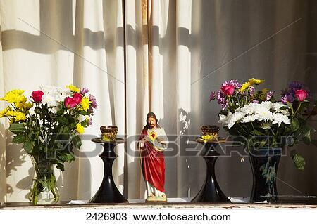 Flowers, candles and a statue of Jesus on a window ledge; Dingle Town, County Kerry, Ireland View Large Photo Image Stock Image - Flowers, candles and a statue of Jesus on a window ledge; Dingle Town, County Kerry, Ireland. Fotosearch