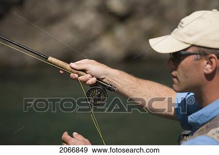 Stock Photo - Fly-Fishing Guide, Russ Trand, Fly-Fishing On Tributary Of Elk River Near Fernie, Elk Valley, East Kootenays, British Columbia, Canada.. Fotosearch