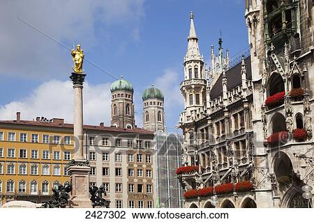 Stock Image - Frauenkirche in Marienplatz, with the Marian column; Munich, Bayern, Germany. Fotosearch