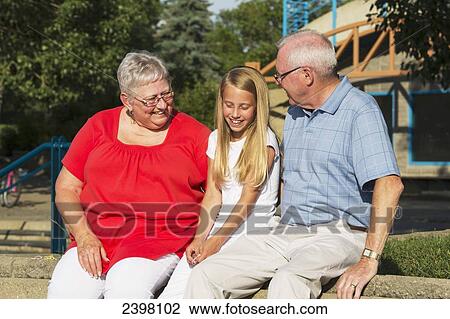Stock Image - Girl spending time with her grandparents; Edmonton, Alberta, Canada. Fotosearch