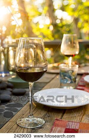 Glasses of red wine on a table set for a meal; Ontario, Canada View Large Photo Image Stock Image - Glasses of red wine on a table set for a meal; Ontario, Canada. Fotosearch