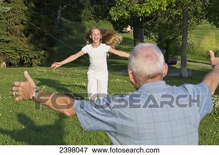 Granddaughter running towards her grandfather in a park; Edmonton, Alberta, Canada View Large Photo Image Stock Photo - Granddaughter running towards her grandfather in a park; Edmonton, Alberta, Canada. Fotosearch