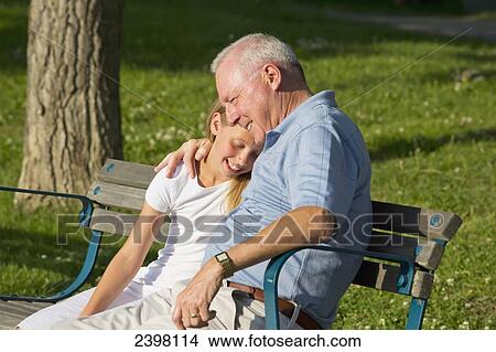 Picture - Grandfather and granddaughter spending quality time together in a park; Edmonton, Albert, Canada. Fotosearch