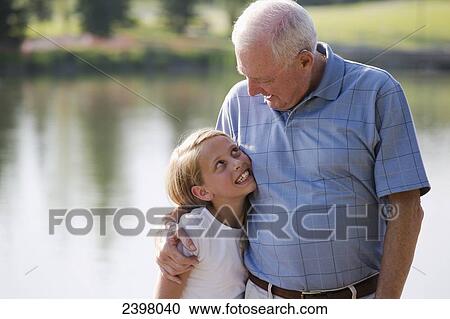 Stock Image - Grandfather and granddaughter spending quality time together in a park; Edmonton, Alberta, Canada. Fotosearch