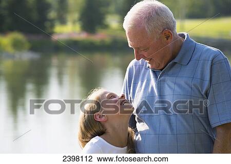 Grandfather and granddaughter spending quality time together in a park; Edmonton, Albert, Canada View Large Photo Image Stock Image - Grandfather and granddaughter spending quality time together in a park; Edmonton, Albert, Canada. Fotosearch