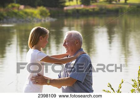 Stock Photo - Grandfather and granddaughter spending quality time together in a park; Edmonton, Albert, Canada. Fotosearch