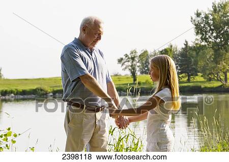 Grandfather and granddaughter spending quality time together in a park; Edmonton, Albert, Canada View Large Photo Image Stock Photo - Grandfather and granddaughter spending quality time together in a park; Edmonton, Albert, Canada. Fotosearch