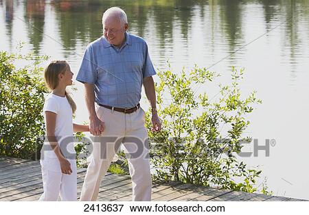 Grandfather and granddaughter spending quality time together in a park; Edmonton, Alberta, Canada View Large Photo Image Stock Photo - Grandfather and granddaughter spending quality time together in a park; Edmonton, Alberta, Canada. Fotosearch