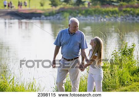 Stock Photography - Grandfather and granddaughter spending quality time together in a park; Edmonton, Albert, Canada. Fotosearch