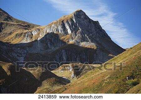 Grass covered slopes in autumn with a mountain peak; Hintertux, Austria View Large Photo Image Stock Photo - Grass covered slopes in autumn with a mountain peak; Hintertux, Austria. Fotosearch