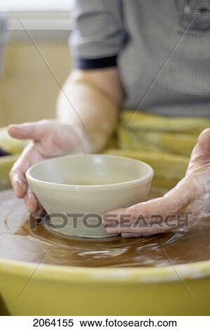 Stock Photography - Hands Molding A Piece Of Pottery On A Wheel-Head, Burlington, Ontario. Fotosearch