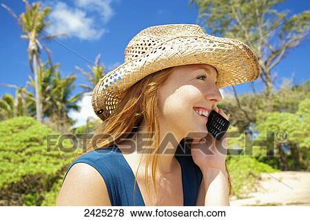 Hawaii, a redheaded woman talking on her cell phone. View Large Photo Image Stock Photo - Hawaii, a redheaded woman talking on her cell phone.. Fotosearch