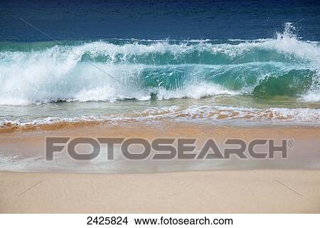Hawaii, Maui, Makena, Crystal clear ocean wave crashing on a white sandy beach. View Large Photo Image Picture - Hawaii, Maui, Makena, Crystal clear ocean wave crashing on a white sandy beach.. Fotosearch