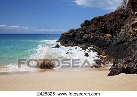 Hawaii, Maui, Makena, Crystal clear ocean wave crashing on a white sandy beach and rocky shore. View Large Photo Image Stock Photography - Hawaii, Maui, Makena, Crystal clear ocean wave crashing on a white sandy beach and rocky shore.. Fotosearch