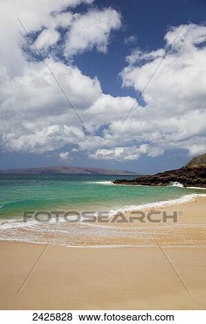 Stock Photo - Hawaii, Maui, Makena, Rocky shore of Makena beach, land in distance.. Fotosearch