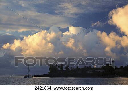 Picture - Hawaii, Oahu, Waimea Bay, A moody evening with puffy clouds.. Fotosearch