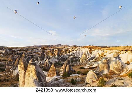 Hot air balloons in the sky above the fairy chimneys; Goreme, Cappadocia, Turkey View Large Photo Image Stock Photo - Hot air balloons in the sky above the fairy chimneys; Goreme, Cappadocia, Turkey. Fotosearch