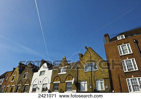 Stock Image - Houses in a row with peaked roofs, Camden; London, England. Fotosearch