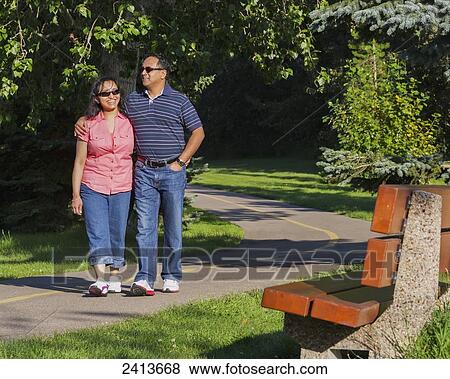 Stock Photo - Husband and wife spending quality time together outdoors in a park; Edmonton, Alberta, Canada. Fotosearch