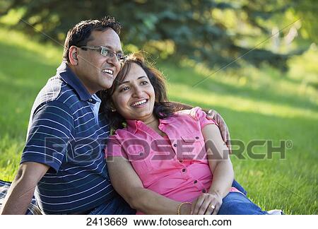 Stock Photo - Husband and wife spending quality time together outdoors in a park; Edmonton, Alberta, Canada. Fotosearch