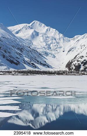 Ice breaking apart on the surface of Portage Lake with reflections of the Chugach mountains in the water in springtime, Chugach National Forest; Alaska, United States of America View Large Photo Image Stock Photo - Ice breaking apart on the surface of Portage Lake with reflections of the Chugach mountains in the water in springtime, Chugach National Forest; Alaska, United States of America. Fotosearch
