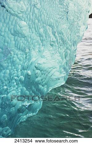 Iceberg broken off Mendenhall Glacier floating in Mendenhall lake, flipping over and exposing blue polished ice from being underwater; Juneau, Alaska, United States of America View Large Photo Image Picture - Iceberg broken off Mendenhall Glacier floating in Mendenhall lake, flipping over and exposing blue polished ice from being underwater; Juneau, Alaska, United States of America. Fotosearch