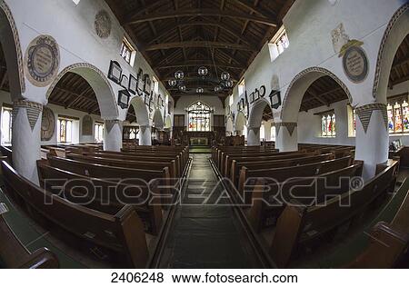 Stock Photo - Interior of a church with a centre aisle and wooden pews; Hawkshead, Cumbria, England. Fotosearch