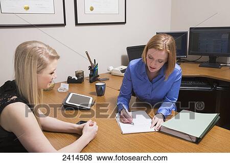 Intern receiving instruction from a superior; Edmonton, Alberta, Canada View Large Photo Image Stock Photo - Intern receiving instruction from a superior; Edmonton, Alberta, Canada. Fotosearch