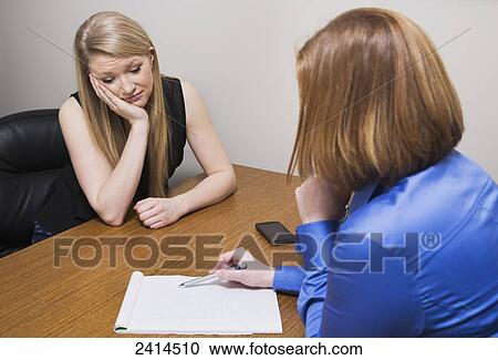 Stock Photography - Intern receiving job evaluation from a superior; Edmonton, Alberta, Canada. Fotosearch - Search Stock Photos, Pictures, Wall Murals, Images, and Photo Clipart
