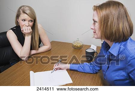 Stock Photography - Intern receiving job evaluation from a superior; Edmonton, Alberta, Canada. Fotosearch - Search Stock Photos, Pictures, Prints, Images, and Photo Clip Art