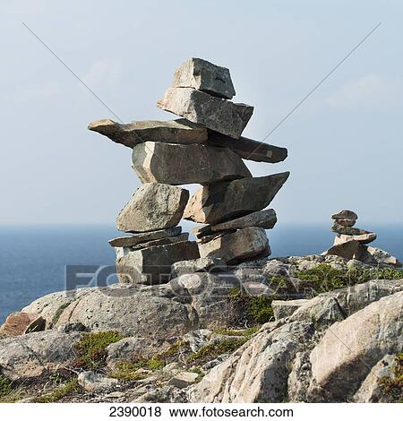 Stock Photo - Inukshuk on the shore of the atlantic coast; Newfoundland and Labrador, Canada. Fotosearch