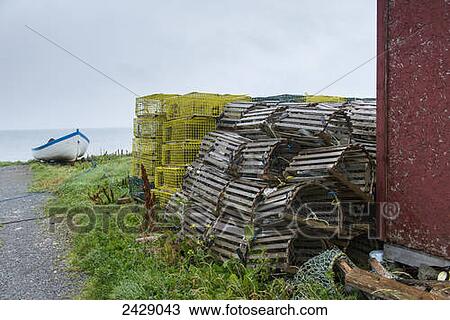 Lobster traps piled by a harbour; Sally's Cove, Newfoundland, Canada View Large Photo Image Stock Image - Lobster traps piled by a harbour; Sally's Cove, Newfoundland, Canada. Fotosearch