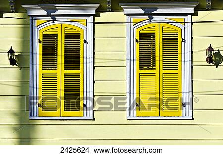 Picture - Louisiana, New Orleans, Exterior of a bright yellow home.. Fotosearch