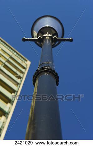 Low angle view of a lamp post, building and blue sky; London, England View Large Photo Image Stock Photo - Low angle view of a lamp post, building and blue sky; London, England. Fotosearch