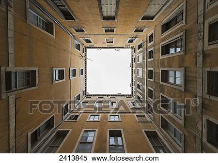 Low angle view to the sky from inside the four walls of a building; Venice, Veneto, Italy View Large Photo Image Stock Photography - Low angle view to the sky from inside the four walls of a building; Venice, Veneto, Italy. Fotosearch