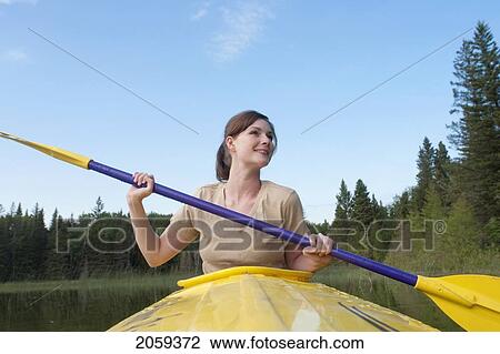 Low Angle, Young Woman Paddling In Yellow Kayak, Lake Katherine, Riding Mountain National Park, Manitoba, Canada View Large Photo Image Stock Image - Low Angle, Young Woman Paddling In Yellow Kayak, Lake Katherine, Riding Mountain National Park, Manitoba, Canada. Fotosearch