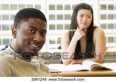 Male Student Foreground, Female Student Background, In Front Of Solar Panelled Windows, Winnipeg, Canada View Large Photo Image Stock Photo - Male Student Foreground, Female Student Background, In Front Of Solar Panelled Windows, Winnipeg, Canada. Fotosearch