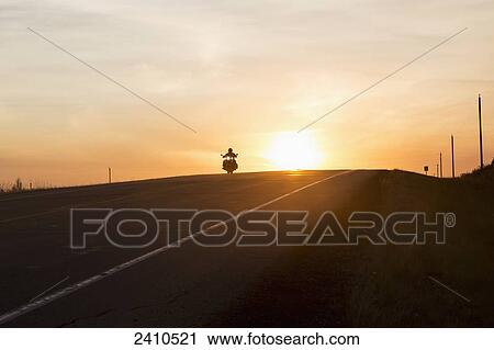 Man on a motorcycle at twilight on a highway, near Edmonton; Alberta, Canada View Large Photo Image Stock Image - Man on a motorcycle at twilight on a highway, near Edmonton; Alberta, Canada. Fotosearch