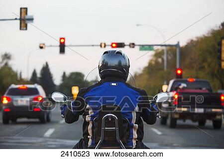 Man on a motorcycle in traffic; Edmonton, Alberta, Canada View Large Photo Image Stock Image - Man on a motorcycle in traffic; Edmonton, Alberta, Canada. Fotosearch