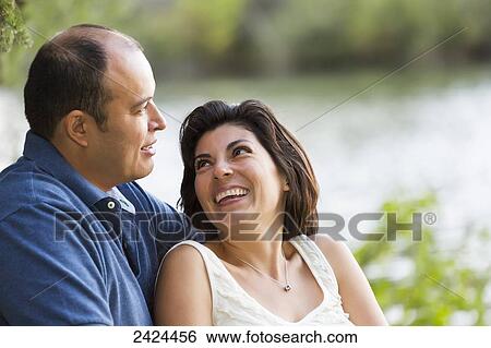 Stock Photograph - Married couple in a park spending quality time together; Edmonton, Alberta, Canada. Fotosearch