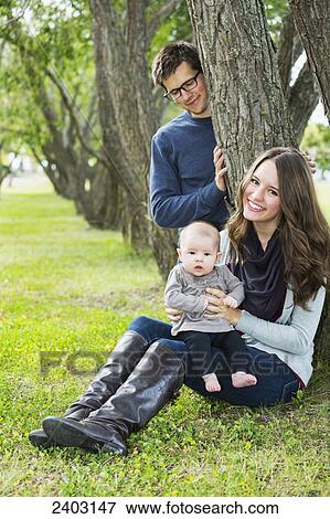 Married couple in a park with a baby; Edmonton, Alberta, Canada View Large Photo Image Stock Photo - Married couple in a park with a baby; Edmonton, Alberta, Canada. Fotosearch