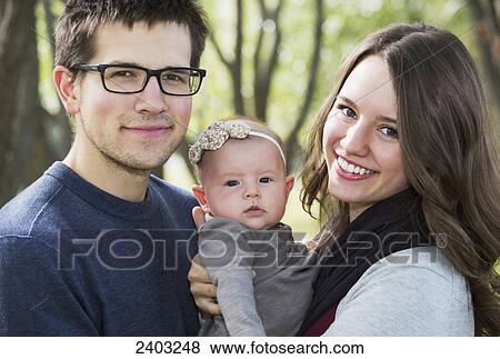 Married couple in a park with a baby; Edmonton, Alberta, Canada View Large Photo Image Stock Photo - Married couple in a park with a baby; Edmonton, Alberta, Canada. Fotosearch
