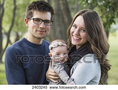 Married couple in a park with a baby; Edmonton, Alberta, Canada View Large Photo Image Stock Photography - Married couple in a park with a baby; Edmonton, Alberta, Canada. Fotosearch