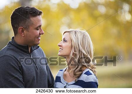 Stock Image - Married couple spending quality time together in a park in autumn; Edmonton, Alberta, Canada. Fotosearch