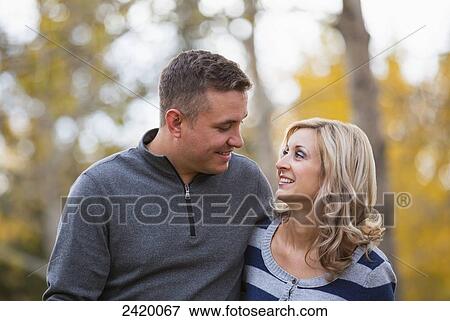 Stock Photo - Married couple spending quality time together in a park in autumn; Edmonton, Alberta, Canada. Fotosearch